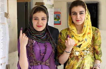 Iraqi women proudly display their fingers stained with ink, indicating they voted in Oct. 2021 national elections.